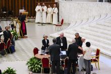 From left foreground front to camera, Sr. Nathalie Becquart, Synod of Bishops' Rapporteur Cardinal Jean-Claude Hollerich and Synod of Bishops' Secretary-General Cardinal Mario Grech attend with Pope Francis a session of the 16th general assembly of the synod of bishops in the Paul VI Hall at the Vatican, Oct. 16. (AP/Domenico Stinellis)