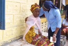 Sr. Victoria Amie Tholley, a member of Sisters of St. Joseph of Cluny, consoles Nana Kamara on Sept. 20.