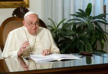 Pope Francis smiles after delivering his speech by video from the Vatican to religious leaders attending the inauguration of the Faith Pavilion at the U.N. climate change conference Dec. 3 in Dubai, United Arab Emirates. Pope Francis canceled his trip to Dubai because of a bronchial infection. (CNS/Vatican Media)