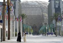 People walk through the COP28 U.N. climate summit Dec. 13 in Dubai, United Arab Emirates. (AP photo/Peter Dejong)