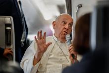 Pope Francis answers a question from a journalist aboard his flight back to Rome Sept. 13, 2024, after visiting Indonesia, Papua New Guinea, Timor-Leste and Singapore. (CNS/Lola Gomez)