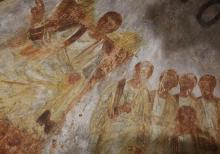 Jesus is seated on a throne with his disciples at his side in this fresco seen during the unveiling of two newly restored burial chambers in the Christian catacombs of St. Domitilla in Rome on May 30, 2017. (CNS/Carol Glatz)