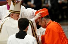 Pope Francis places a red biretta on new U.S. Cardinal Robert W. McElroy of San Diego during a consistory for the creation of 20 new cardinals in St. Peter's Basilica at the Vatican Aug. 27. (CNS/Paul Haring)