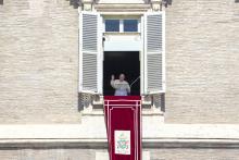 Pope Francis delivers his blessing as he recites the Angelus noon prayer from the window of his studio overlooking St.Peter's Square, at the Vatican, Sunday, Sept. 5, 2021. (AP Photo/Andrew Medichini)