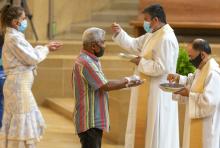 The faithful wear masks and some wear gloves as they receive Communion at the first English Mass with faithful present at the Cathedral of Our Lady of the Angels June 7, 2020, in downtown Los Angeles. (AP/Damian Dovarganes)