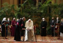 Flanked by leaders of major world religions Oct. 4 at the Vatican, Pope Francis signs a joint appeal to government leaders to curb global warming and heal the planet. (CNS/Paul Haring)