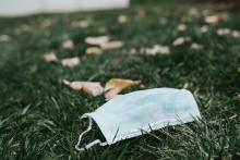 Discarded face mask on lying on the grass