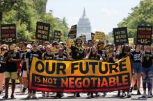 Young climate activists march toward the White House in Washington June 28. (CNS photo/Evelyn Hockstein, Reuters)