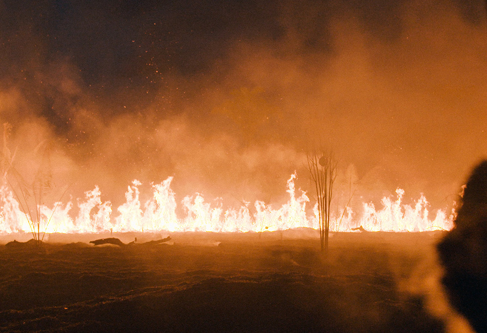 A fire lit by local farmers burns in the Amazon rainforest during the summer of 2019. (Films.NationalGeographic.com/Amazon Land Documentary/Alex Pritz)