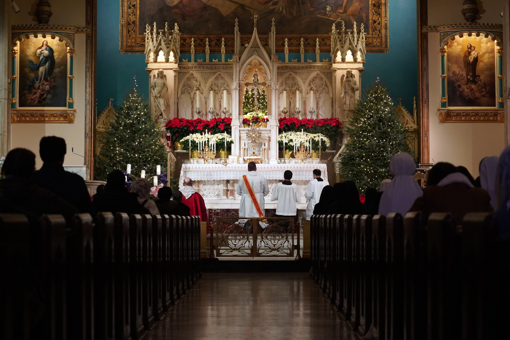 Worshipers kneel in prayer during eucharistic adoration following a Mass marking the feast of the Holy Innocents Dec. 28, 2020, at the Church of the Holy Innocents in New York City. (CNS/Gregory A. Shemitz)