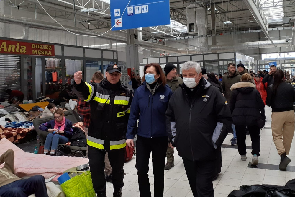 Cardinal Konrad Krajewski, the papal almoner, visits Ukrainian refugees in Korczowa, Poland, March 8 at a supermarket that was turned into a temporary refugee center. (CNS)