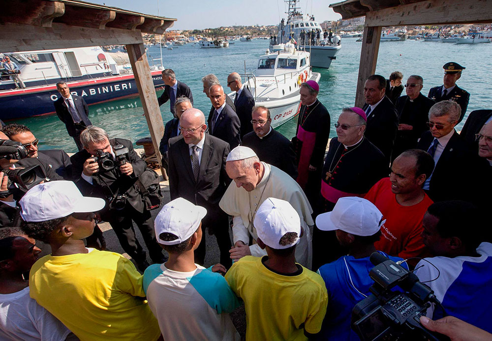 Pope Francis talks with migrants at the port in Lampedusa, Italy, July 8, 2013. (CNS/Pool via Reuters)