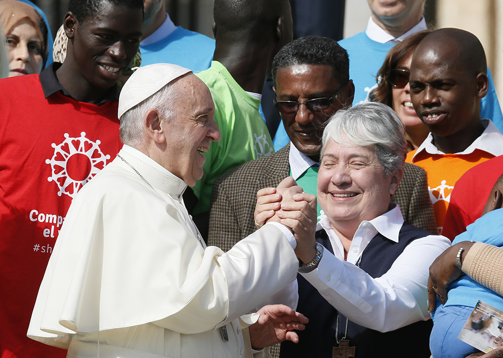 Pope Francis greets Missionaries of Jesus Sr. Norma Pimentel, executive director of Catholic Charities of the Rio Grande Valley in Texas, as he meets immigrants and representatives of Caritas Internationalis during his general audience in St. Peter's Square at the Vatican Sept. 27, 2017. (CNS/Paul Haring)