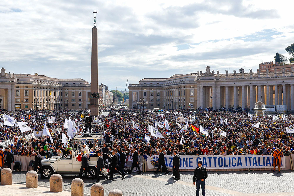Pope Francis greets people as he rides the popemobile around St. Peter's Square before a meeting with members of Italy's Catholic Action lay association at the Vatican April 25, 2024. (CNS/Lola Gomez)