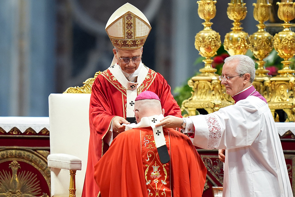 Pope Leo XIV presents the pallium to Archbishop Edward Weisenburger of Detroit during Mass in St. Peter’s Basilica at the Vatican June 29, 2025, the feast of Sts. Peter and Paul. The pallium symbolizes the archbishop’s authority and unity with the pope. (CNS/Lola Gomez)