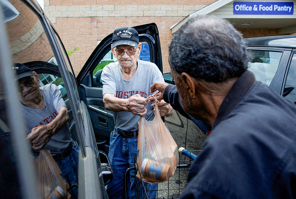 Volunteer Walter Rogers, 83, helps Merrill Hancock, 87, load the groceries he received May 12, 2025, from the Eastside Community Ministry pantry in Zanesville, Ohio. (OSV News/Reuters/Evelyn Hockstein)