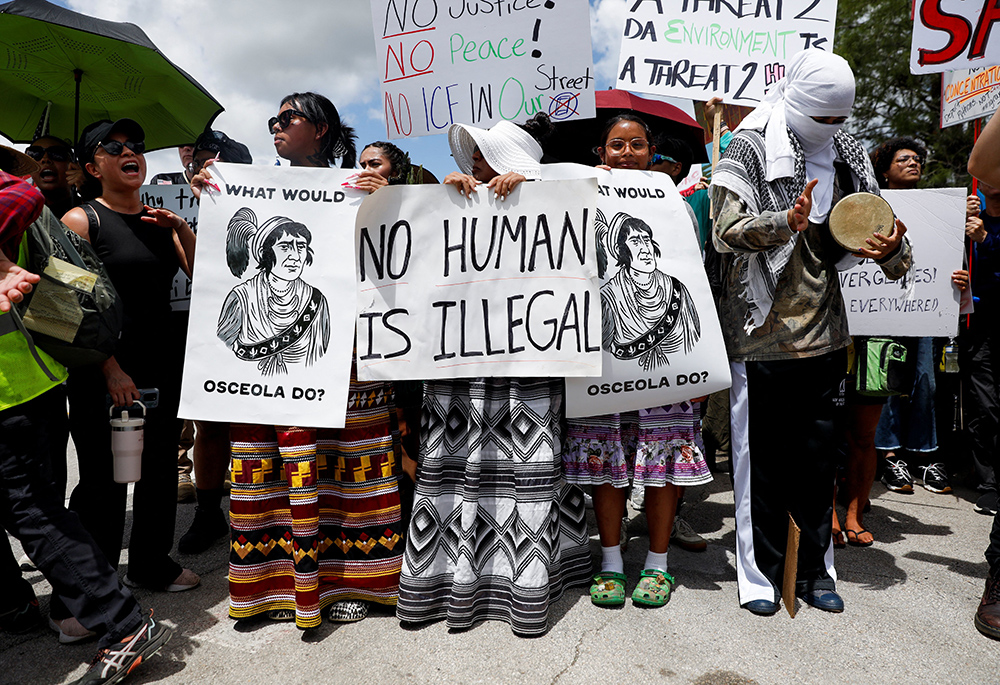 Protesters flank an entrance road at a temporary migrant detention center nicknamed "Alligator Alcatraz" in Ochopee, Florida, July 1, 2025, the day U.S. President Donald Trump visited the facility. (OSV News/Reuters/Octavio Jones)