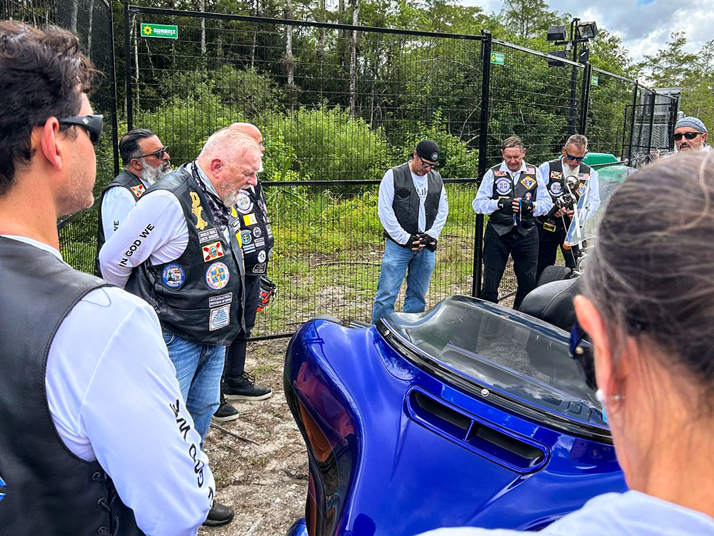 Archbishop Thomas Wenski of Miami and Knights on Bikes pray the rosary for detainees at the entrance to Alligator Alcatraz, a controversial immigration detention facility some 55 miles from Miami in the Florida Everglades, July 20, 2025. (OSV News/Thomas G. Wenski)