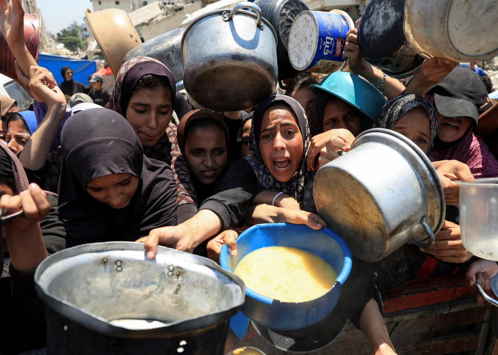 Palestinians gather to receive food from a charity kitchen in Gaza City July 24, 2025, amid a hunger crisis. For months, U.N. officials, aid groups and experts have warned that Palestinians in the Gaza Strip are on the brink of famine without formally declaring one. (OSV News/Dawoud Abu Alkas/Reuters)