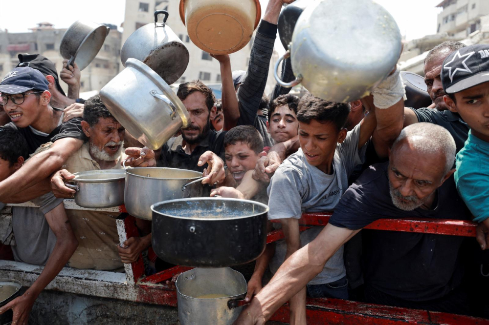Palestinians gather to receive food from a charity kitchen amid a hunger crisis in the central Gaza Strip July 29, 2025. (OSV News photo/Hatem Khaled/Reuters)