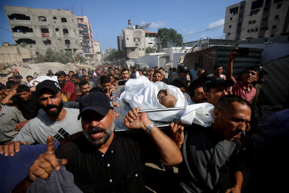 Mourners carry bodies of Palestinians in Gaza City.