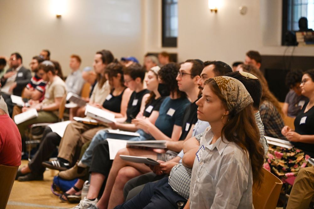 Group sits at forum.