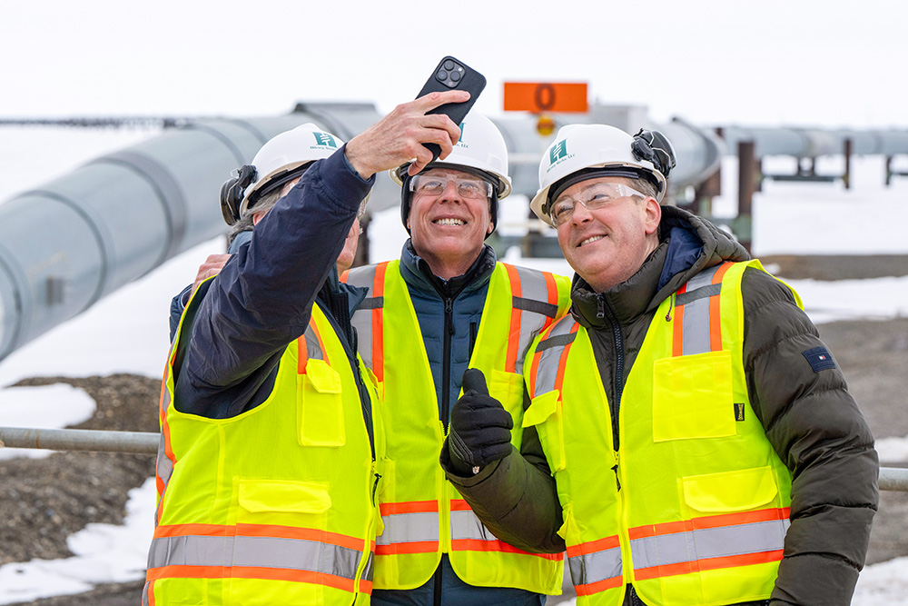 From left, Interior Secretary Doug Burgum, Energy Secretary Chris Wright and Environmental Protection Agency Administrator Lee Zeldin pose for a selfie with the Trans-Alaska oil pipeline in the background after a news conference at Pump Station 1 on June 2, 2025, near Deadhorse, Alaska. (AP/Jenny Kane)