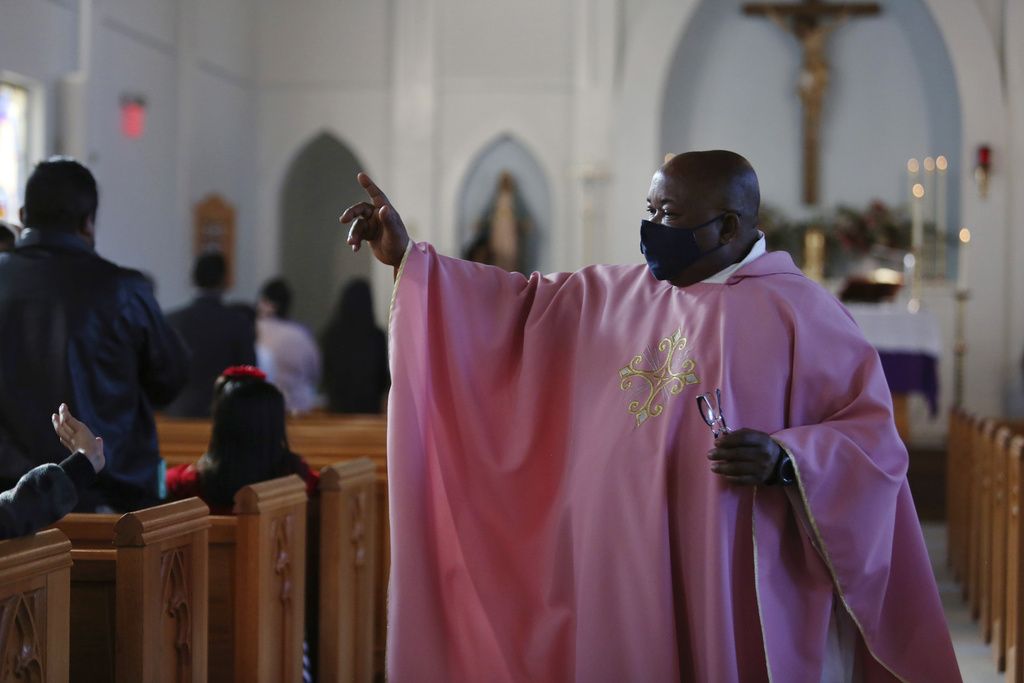 The Rev. Athanasius Abanulo waves to his parishioners after Mass on Dec. 12, 2021, at Immaculate Conception Catholic Church in Wedowee, Ala. (AP Photo/Jessie Wardarski, File)