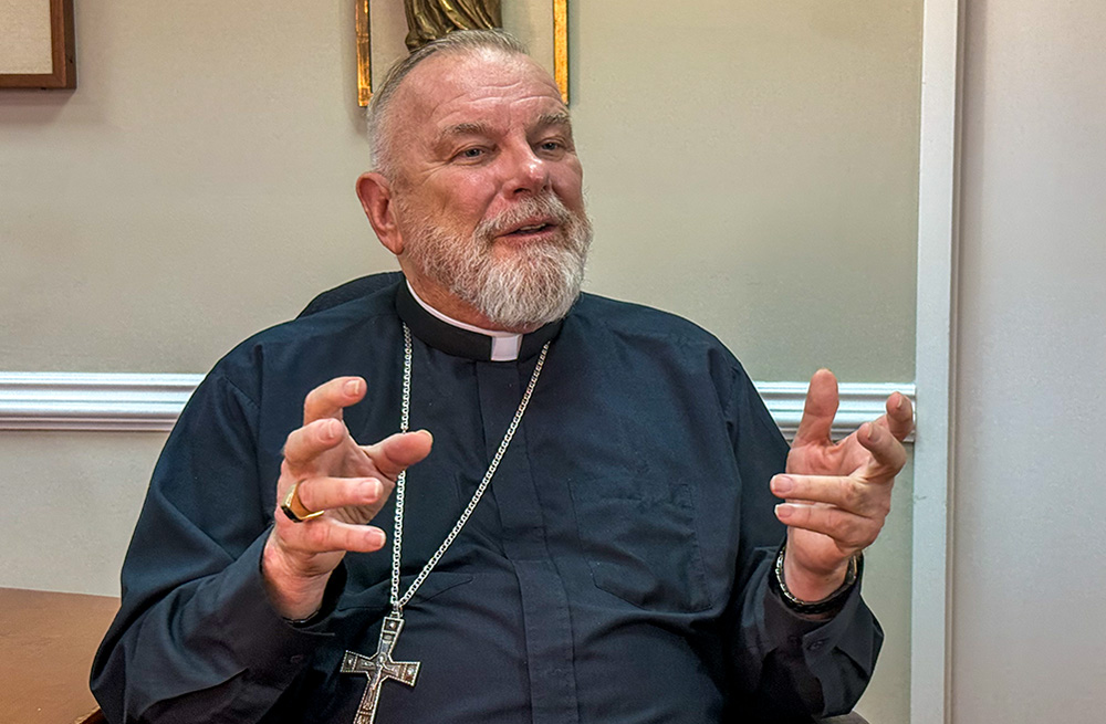 Miami Archbishop Thomas Wenski speaks with reporters July 21, 2025, at the pastoral center of the Miami Archdiocese in Miami Shores, Florida. (NCR photo/Garrett Shanley)