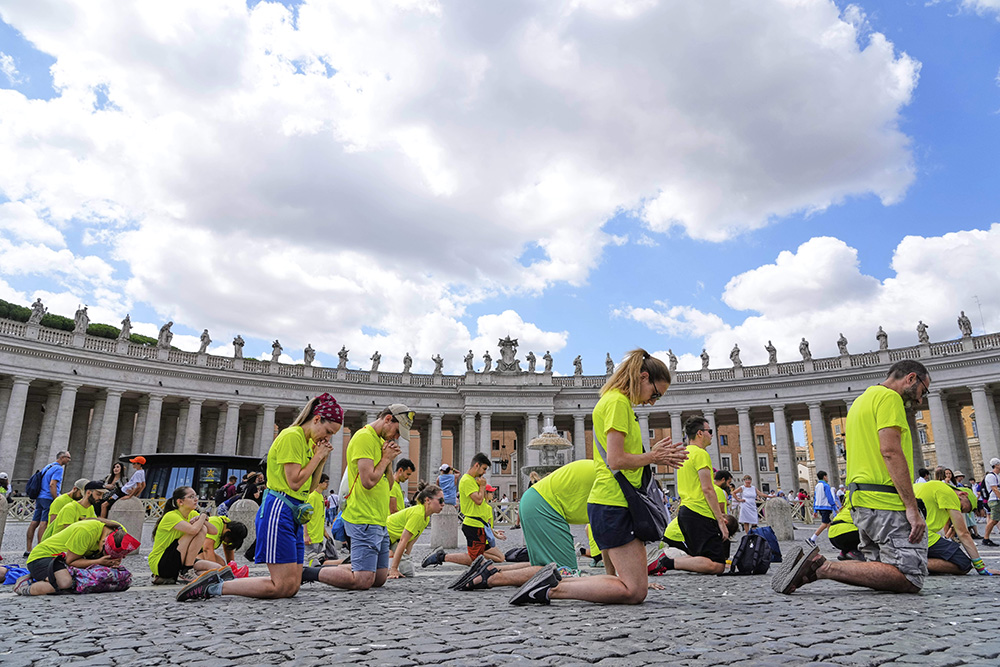 Faithful kneel in prayer proper to the start of Pope Leo XIV's Angelus noon prayer in St. Peter's Square at the Vatican, July 27, 2025. (AP Photo/Gregorio Borgia)