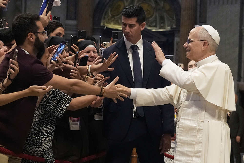 Pope Leo XIV greets faithful at the end of a mass celebrated by Cardinal Luis Antonio Tagle in St. Peter's Basilica on the occasion of the Youth Jubilee at the Vatican, July 29, 2025. (AP Photo/Gregorio Borgia)