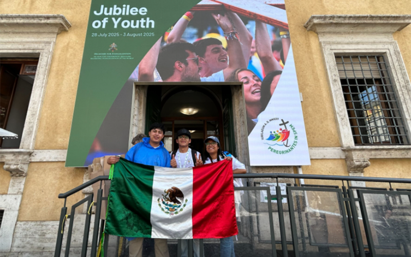 Jesus Antonio Romo Vásquez, from San Luis Potosi, Mexico, center, poses for a photo with two other young pilgrims in front of the Jubilee Office, a check-in spot for pilgrims, during the Jubilee of Youth at the Vatican, on July 28, 2025. (NCR photo/Justin McLellan)