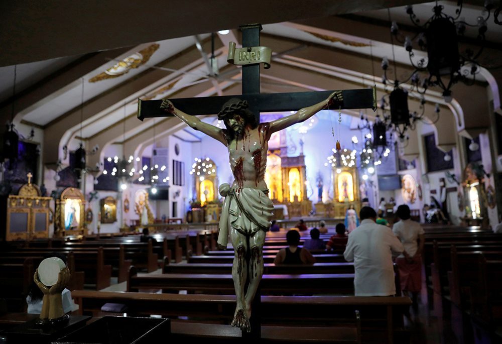 Members of a congregation pray during a Sept. 22, 2017, Mass at a Catholic church in Quezon City, Philippines. (CNS/Reuters/Dondi Tawatao)