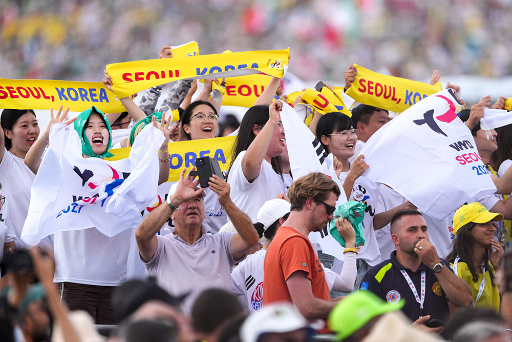 Pilgrims from South Korea hold banners and flags promoting World Youth Day 2027 in Seoul after the closing Mass of the Jubilee of Youth in Rome’s Tor Vergata neighborhood Aug. 3, 2025. (CNS/Lola Gomez)