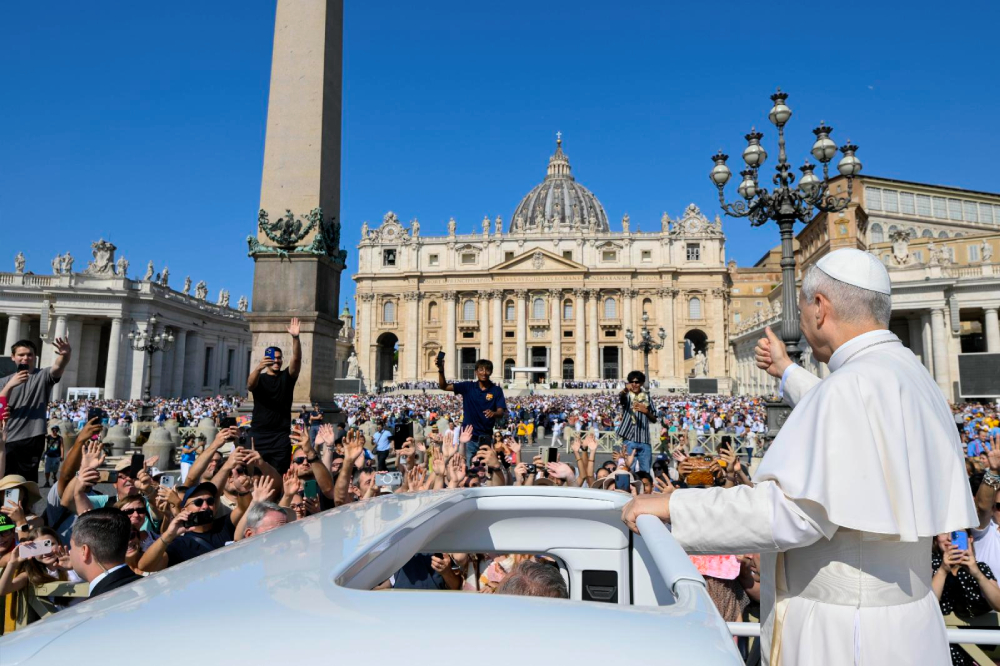 Pope Leo XIV gives a thumbs-up as he rides the popemobile around St. Peter's Square at the Vatican before his weekly general audience Aug. 6, 2025. (CNS/Vatican Media)