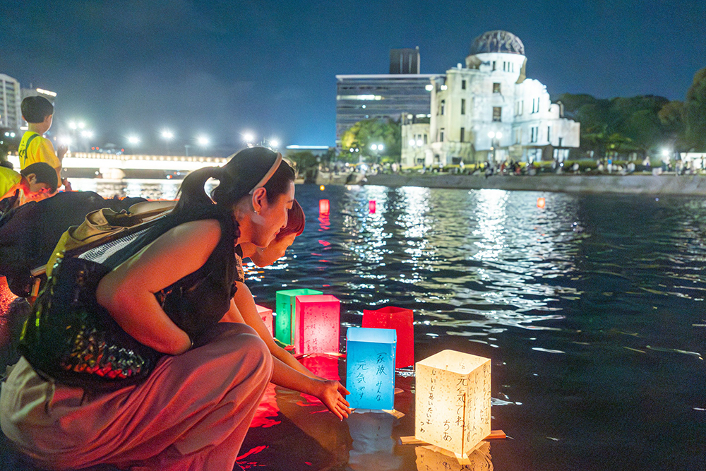 People release paper lanterns on the Motoyasu River facing the gutted Atomic Bomb Dome in Hiroshima, Japan, Aug. 6, 2025, on the 80th anniversary of the United States dropping the atomic bomb on Hiroshima. (OSV News/Catholic Standard/Mihoko Owada)