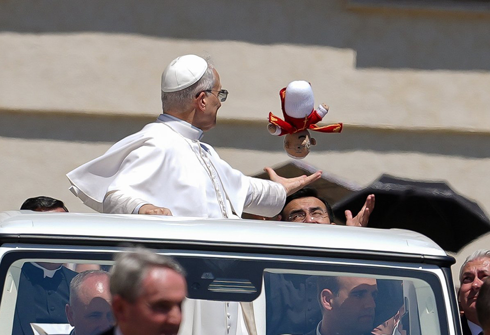 Pope Leo XIV catches a crocheted Pope Leo doll tossed to him as he rode in the popemobile around St. Peter's Square at the Vatican May 28, 2025. (CNS/Lola Gomez)