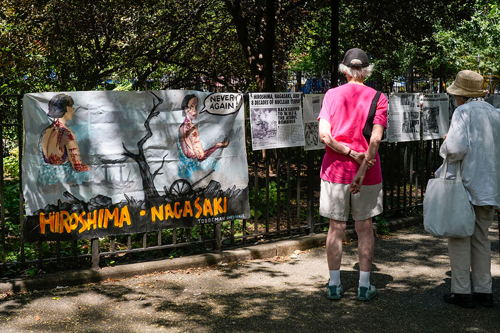 People view an exhibit in Tompkins Square Park in New York City Aug. 9, 2025, marking the 80th anniversary of the Aug. 6, 1945, and Aug. 9, 1945, atomic bombings, respectively, of Hiroshima and Nagasaki, Japan. The exhibit was arranged by the New York City chapter of the War Resisters League to detail the history and horrors of the bombings. (OSV News/Gregory A. Shemitz)