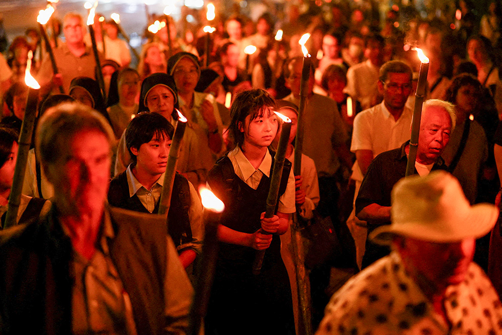 After a Peace Memorial Mass at Urakami Cathedral in Nagasaki, Japan, Aug. 9, 2025, people carry torches during a peace march to Hypocenter Park in commemoration of the 80th anniversary of the U.S. atomic bombing of Nagasaki. (OSV News/Reuters/Issei Kato)