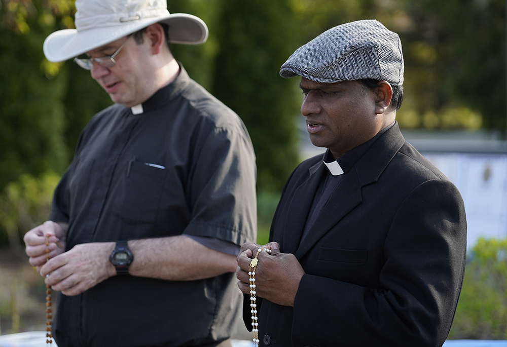 Frs. Charles Gnanapragasam, right, and Thomas Pers participate in a "Keep Our Priests" rosary rally at St. Mary Church in East Islip, New York,, April 29, 2024. More than 300 people gathered to pray for changes in U.S. immigration procedures to prioritize visa and green card applications for foreign-born religious workers, many of whom are being forced to leave the country because of federal delays in processing immigration paperwork. (OSV News/Gregory A. Shemitz)
