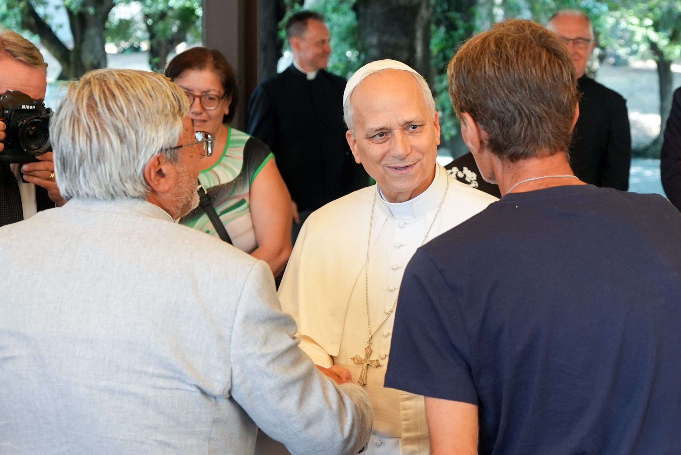 Pope Leo XIV greets lunch guests assisted by the Albano diocesan Caritas agency at the Borgo Laudato Si’ in Castel Gandolfo, Italy, Aug. 17, 2025. The luncheon with the pope followed a Mass the pope celebrated in nearby Albano Laziale. (CNS photo/Lola Gomez)