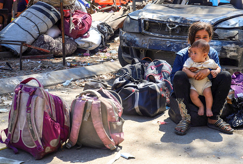Displaced Palestinian children sit near their belongings during an Israeli military operation in Gaza City, Aug. 26, 2025. (OSV News/Reuters/Ebrahim Hajjaj)