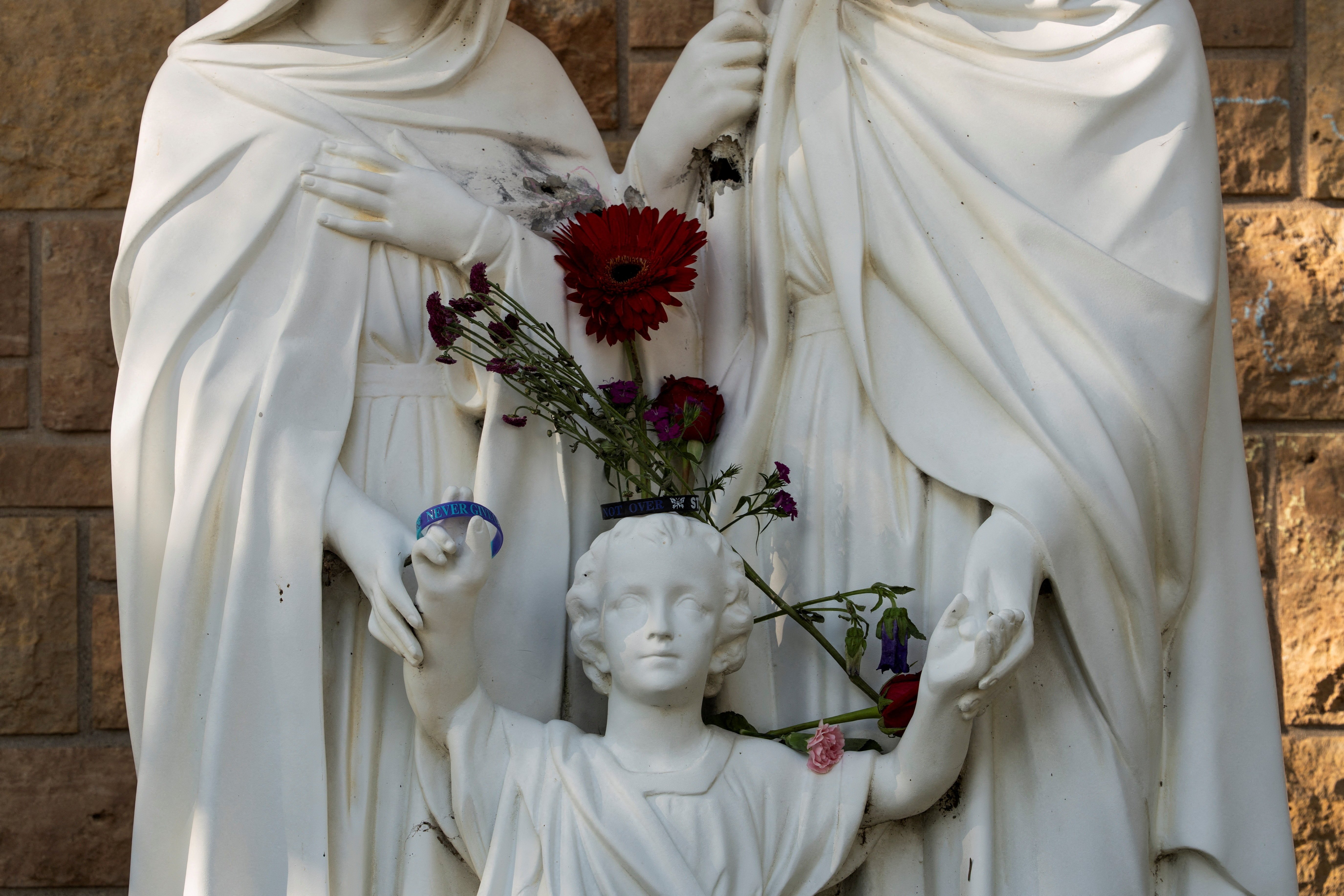A statue of the Holy Family is seen before the first Mass at Annunciation Church in Minneapolis Aug. 30, 2025, which is home to an elementary school and was the scene of a shooting. The shooter opened fire with a rifle through the windows of the school's church and struck children attending Mass Aug. 27 during the first week of school