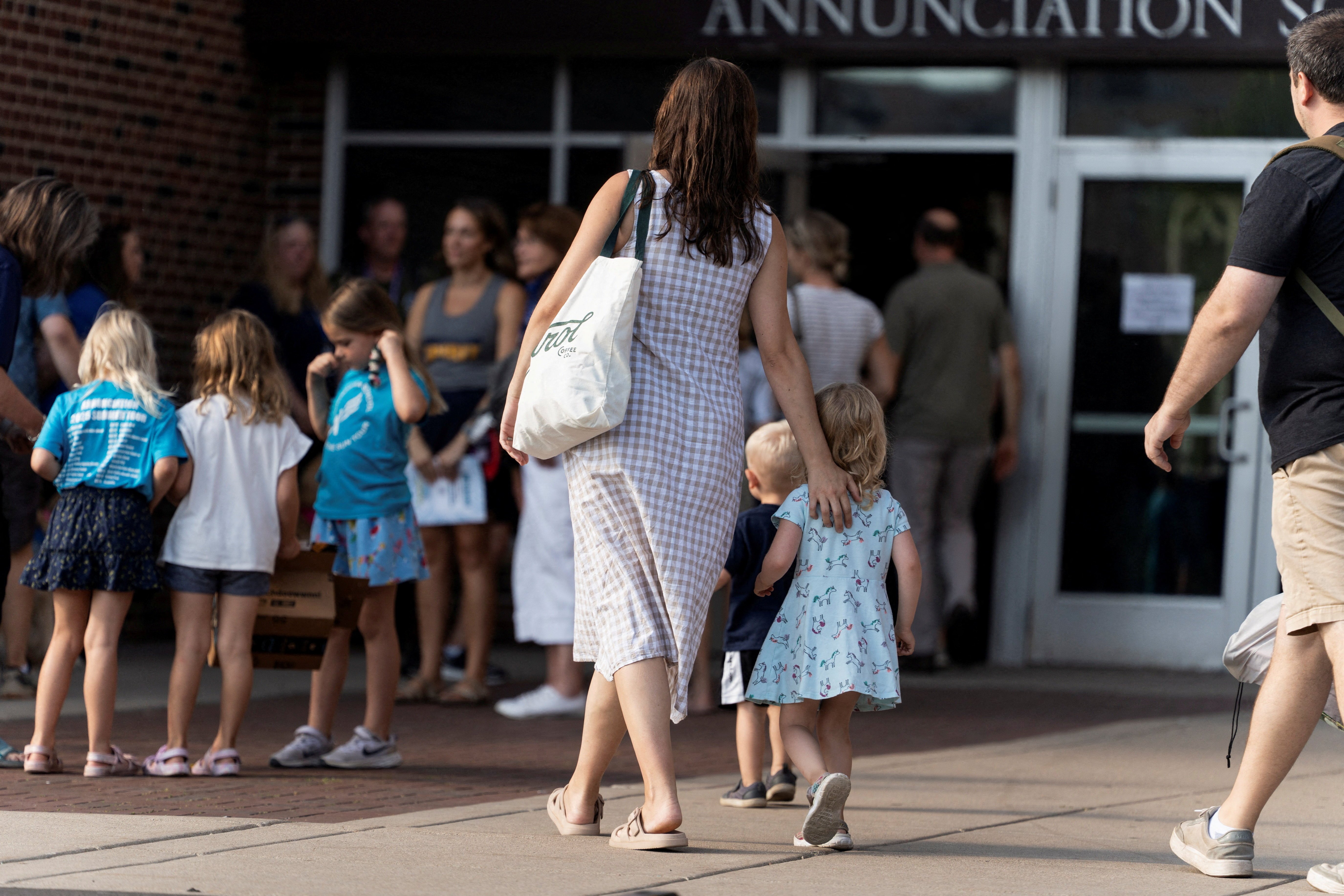 Parishioners arrive for the first Mass at Annunciation Church in Minneapolis Aug. 30, 2025, which is home to an elementary school and was the scene of a shooting. The shooter opened fire with a rifle through the windows of the school's church and struck children attending Mass Aug. 27 during the first week of school, killing two and wounding 18 others. (OSV News photo/Tim Evans, Reuters)