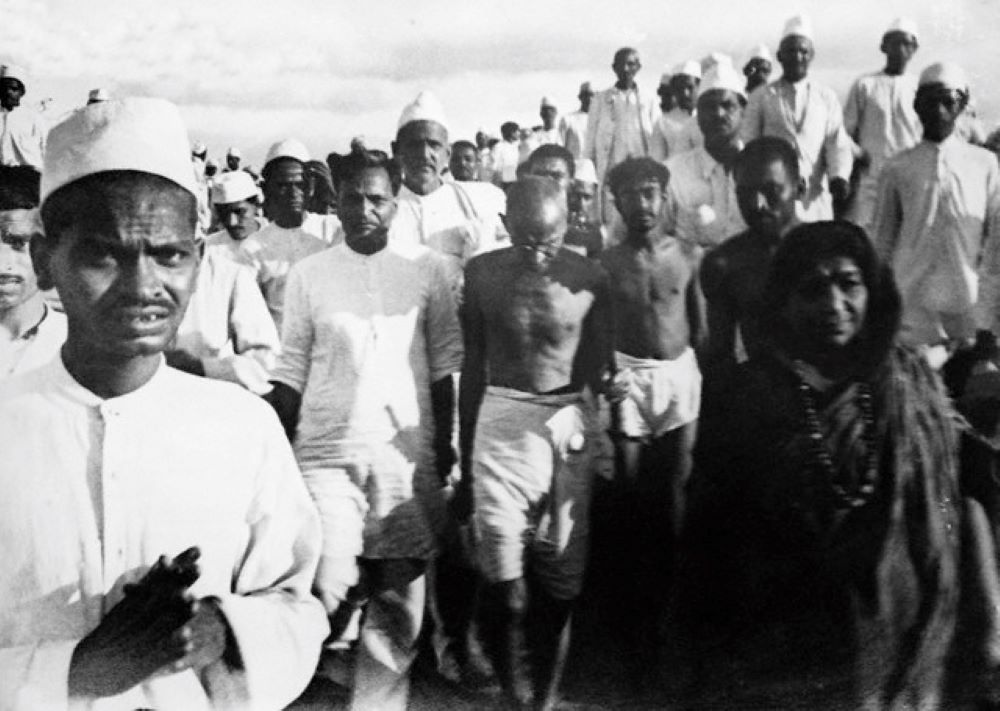 Mohandas Gandhi and others walk during a peaceful protest in 1930. 