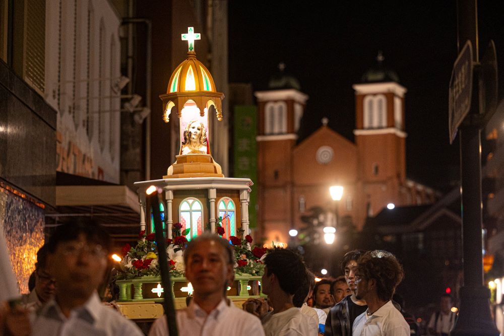 People in procession outside Urakami Cathedral in Nagasaki, Japan 