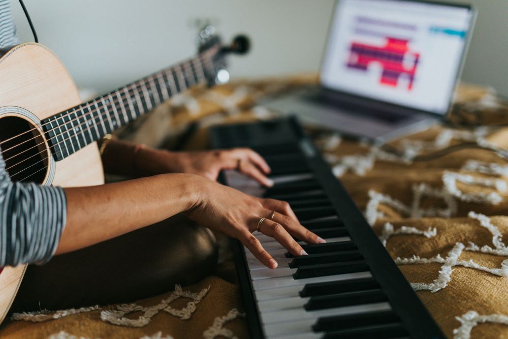 Person with guitar and keyboard