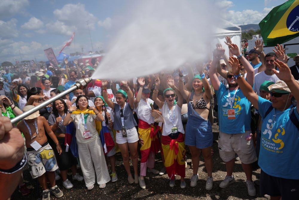 Water sprayed on crowd of young people.