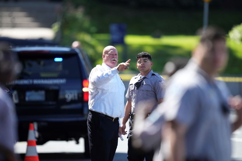 Law enforcement officers gather outside the Annunciation Church's school.