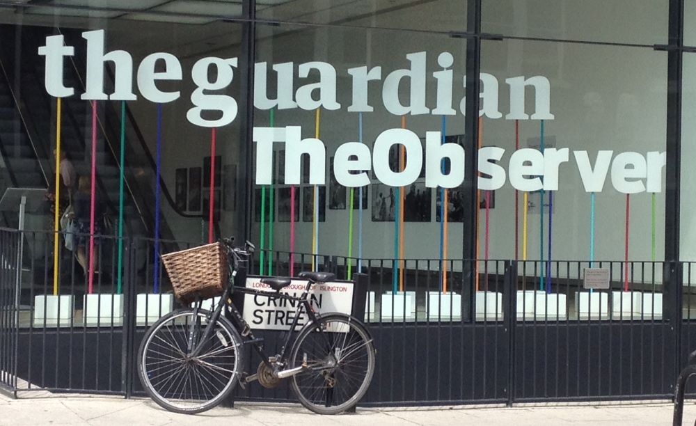 A 2012 photo shows a window at the entrance to the building housing The Guardian newspaper in London.
